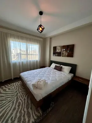 a bedroom with a large bed and a window at 3 minutes de casa voyageurs in Casablanca