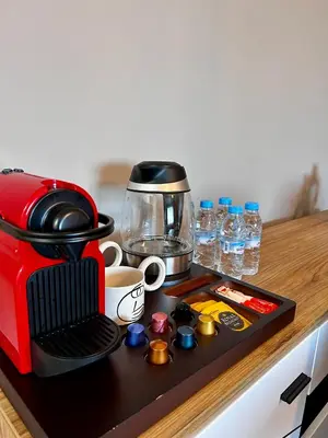 a red coffee maker sitting on a kitchen counter at 3 minutes de casa voyageurs in Casablanca