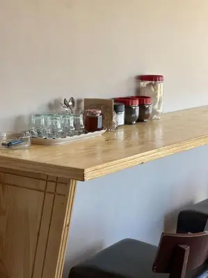 a wooden table with glasses on top of it at La Casa Blanca • Ecolodge Vert in Oulad Youssef