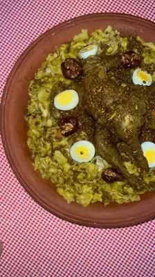 a plate of food with eggs on top of rice at La Casa Blanca • Ecolodge Vert in Oulad Youssef