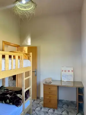 a bedroom with a bunk bed and a desk at La Casa Blanca • Ecolodge Vert in Oulad Youssef