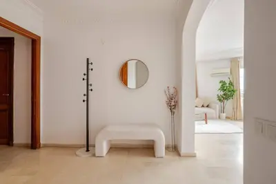 a white room with a bench and a mirror at TT Holidays 3BR Racine Casablanca in Casablanca