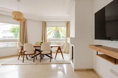 a white living room with a table and chairs at TT Holidays 3BR Racine Casablanca in Casablanca