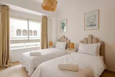 a bedroom with two beds and a window at TT Holidays 3BR Racine Casablanca in Casablanca