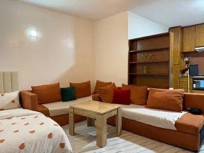 a living room with a couch and a table at Studio la corniche in Rabat