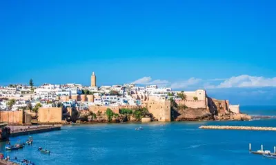 a view of a city from the water with boats at Studio la corniche in Rabat