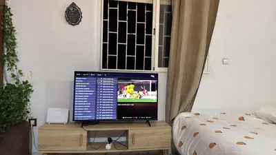 a television sitting on a wooden stand in a room at Studio la corniche in Rabat