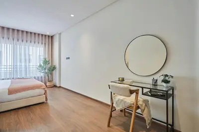 a bedroom with a bed and a desk with a mirror at Modern Elegance 3 Bed Escape in Trendy Casablanca in Casablanca