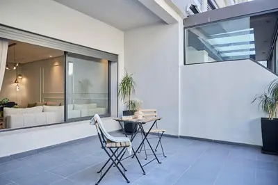 a patio with a table and chairs and a couch at Modern Elegance 3 Bed Escape in Trendy Casablanca in Casablanca