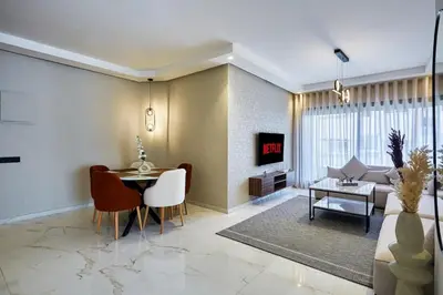 a living room with a table and a couch at Your Home Away from Home 2 Bed Flat With Parking in Casablanca