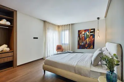 a bedroom with a bed and a table and a chair at Your Home Away from Home 2 Bed Flat With Parking in Casablanca