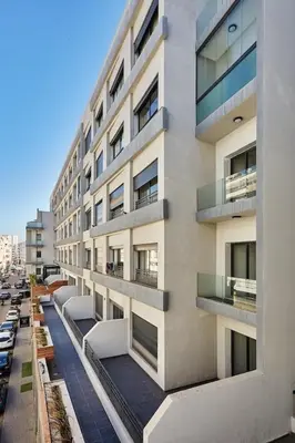 an apartment building with balconies on a city street at Your Home Away from Home 2 Bed Flat With Parking in Casablanca