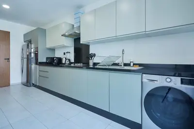 a kitchen with a washing machine in the middle at Discover Casablanca Stay in our 3-Bed Gem with Parking in Casablanca