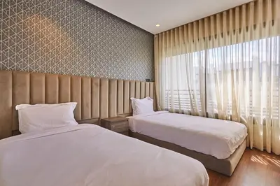 a hotel room with two beds and a window at Discover Casablanca Stay in our 3-Bed Gem with Parking in Casablanca