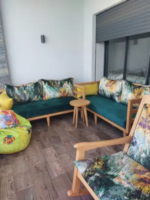 a living room with couches and a table at Dahlia Sidi rahal in Sidi Rahal