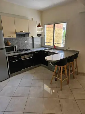 a kitchen with a table and a counter top at Bel appartement en bord de mer in Casablanca