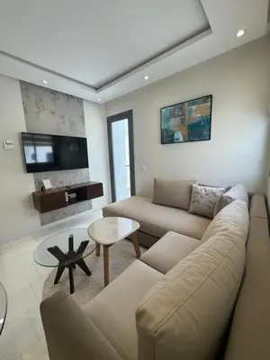 a living room with a couch and a table at au cœur de la Corniche in Casablanca