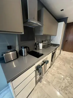 a kitchen with a counter top with a stove at Luxury Maarif Anfa Racine in Casablanca