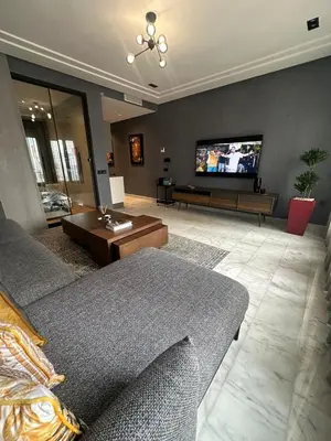 a living room with a couch and a flat screen tv at Luxury Maarif Anfa Racine in Casablanca