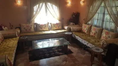 a living room with a couch and a window at Villa entièrement meublée à louer à Mohammedia in Mohammedia