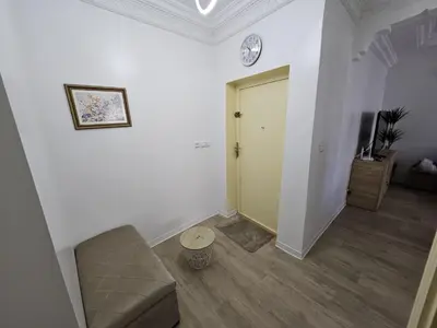 a living room with a couch and a yellow door at Cosy and Complete Casa appartment in Casablanca