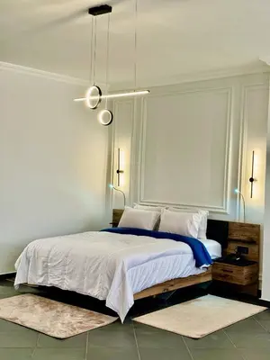 a bedroom with a large bed with white sheets and pillows at The Hotel Syracuse in Casablanca
