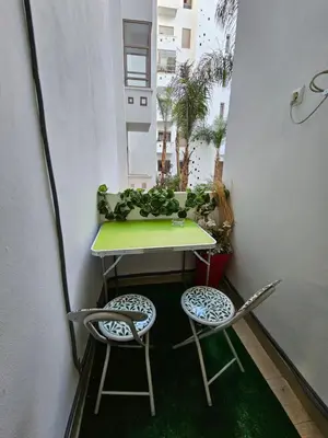 a small table and two chairs on a balcony at MIA Appartement N1 - Élégance, Confort et Sérénité in Casablanca