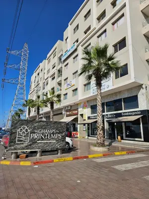 a sign in front of a building with a palm tree at MIA Appartement N1 - Élégance, Confort et Sérénité in Casablanca