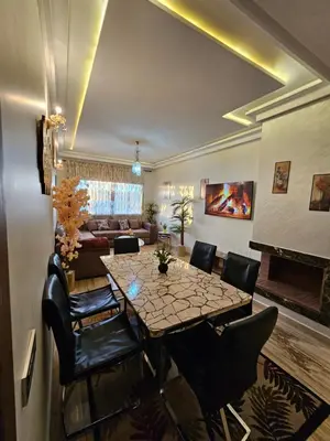 a dining room with a table and chairs and a couch at MIA Appartement N1 - Élégance, Confort et Sérénité in Casablanca