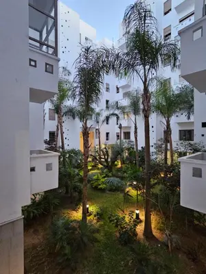 an apartment courtyard with palm trees and lights at MIA Appartement N1 - Élégance, Confort et Sérénité in Casablanca