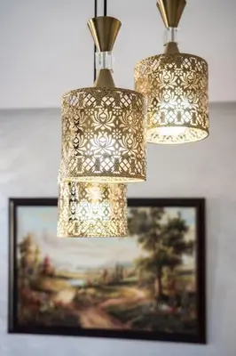 two chandeliers hanging above a picture of a painting at Stylish Studio à Ain Sebaa in Casablanca