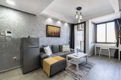 a living room with a couch and a refrigerator at Stylish Studio à Ain Sebaa in Casablanca