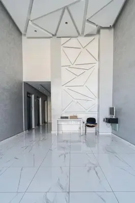a lobby with a chair and a table in a building at Chic Apartment Cosy Stay in Casablanca