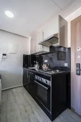 a kitchen with a black stove top oven at Chic Apartment Cosy Stay in Casablanca