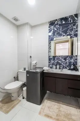 a bathroom with a toilet and a tub and a sink at Chic Apartment Cosy Stay in Casablanca