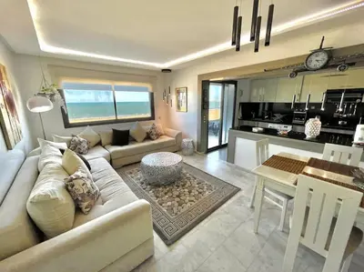 a living room with a couch and a table at Miramar Luxury apartment Front Beach View in Mohammedia