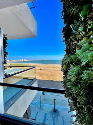 a view of a building with a view of the ocean at Miramar Luxury apartment Front Beach View in Mohammedia