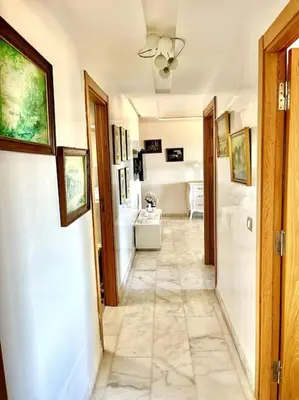 a hallway of a bathroom with a toilet and a sink at Miramar Luxury apartment Front Beach View in Mohammedia