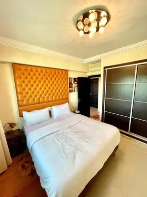a bedroom with a large bed with a large headboard at Fabulous Apartment Beach view in Mohammedia