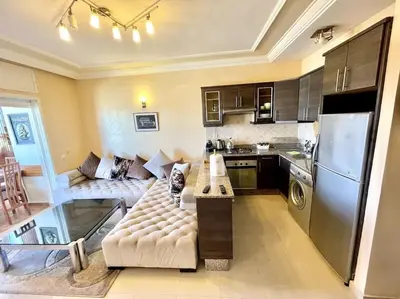 a living room with a couch and a kitchen at Fabulous Apartment Beach view in Mohammedia