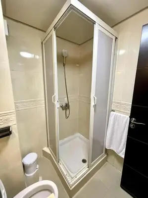 a bathroom with a shower and a toilet at Fabulous Apartment Beach view in Mohammedia
