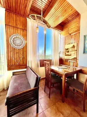 a dining room with a table and a couch and a table and chairs at Fabulous Apartment Beach view in Mohammedia