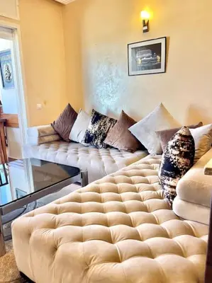 a living room with a couch and a large bed at Fabulous Apartment Beach view in Mohammedia
