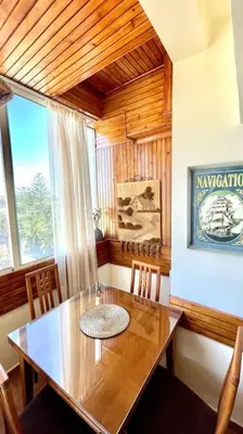 a dining room with a table and chairs and a window at Fabulous Apartment Beach view in Mohammedia