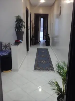 a hallway with rugs on the floor in a house at Appartement Bourgogne casa Anfa in Casablanca