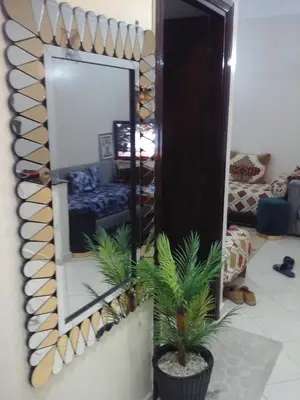 a mirror on a wall in a living room at Appartement Bourgogne casa Anfa in Casablanca
