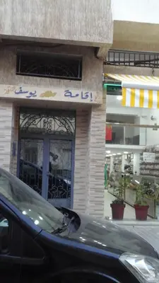 a black car parked in front of a store at Appartement Bourgogne casa Anfa in Casablanca