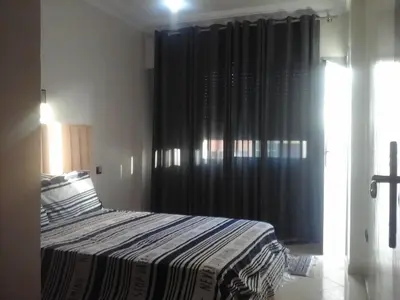 a bedroom with a bed with a black curtain at Appartement Bourgogne casa Anfa in Casablanca