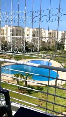a view of a swimming pool from a balcony at Appartement avec piscine in Bouznika