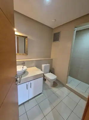 a bathroom with a toilet and a sink and a shower at My Cosy Place - Apartment 2BR - Piscine - Bahia Beach - Bouznika in Bouznika
